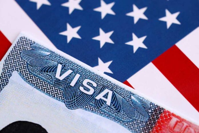 Close-up of a US visa on a background of the American flag
