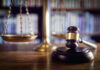KIDNAPPING Claims Stun Courtroom Observers Scales and gavel on a judges desk.