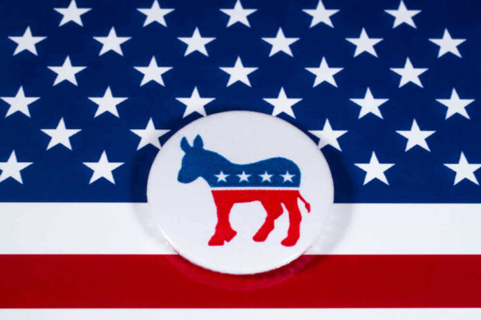 shutterstock_7864500311.jpg Democratic Party donkey logo on American flag background.
