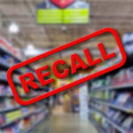 Recall: Metal Fragments Found! Blurred store aisle with RECALL stamp overlay.