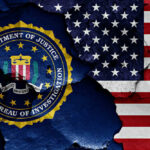 FBI seal superimposed on cracked American flag.