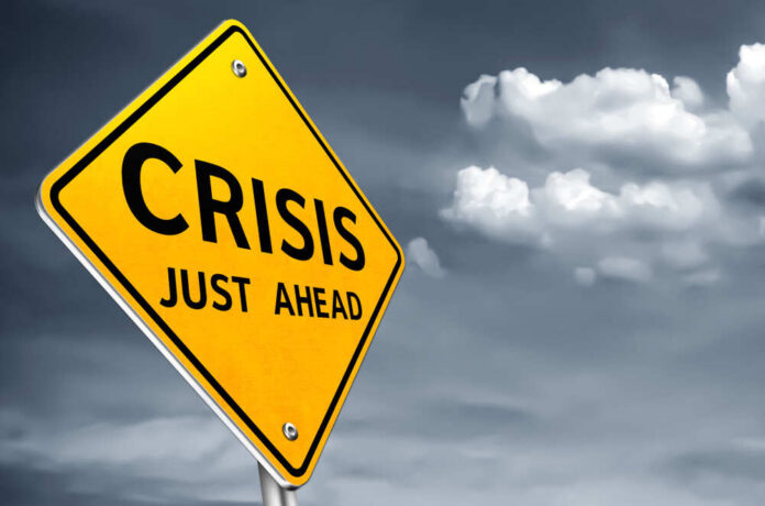 shutterstock_1466766104.jpg A yellow warning sign indicating a crisis ahead