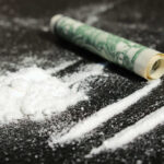 Narco Sub Captured Cocaine lines with rolled banknote on surface