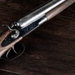 Close-up of an antique shotgun with a wooden stock and metal barrel