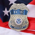 ICE officer badge placed on an American flag