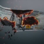 A hundred dollar bill appearing to burn and disintegrate