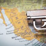 A close-up of a gun resting on a map of Mexico