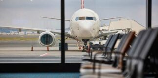 View of an airplane from an airport waiting area