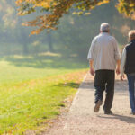 Golden Years, Golden Brain: What’s the Secret? Two people walking together on a park path.