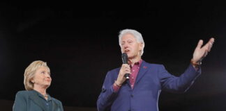 Hillary Clinton and Bill Clinton speaking at a political rally