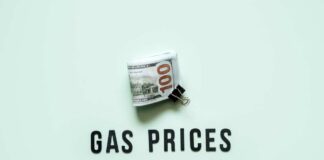 A bundle of cash next to the words 'GAS PRICES' on a light green background