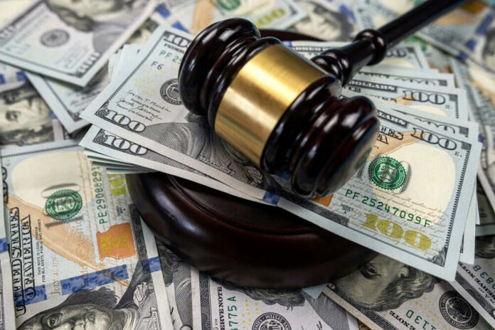 Gavel on pile of hundred dollar bills