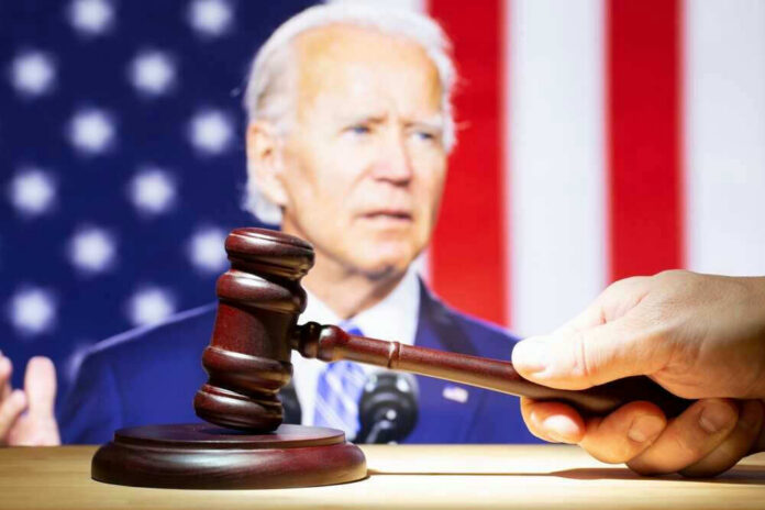 Joe Biden with a hand holding a gavel