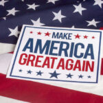 Sign saying Make America Great Again on American flag.
