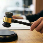 Gavel in judges hand about to strike.
