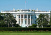 The White House, front view with fountain and flag.