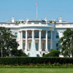 The White House, front view with fountain and flag.