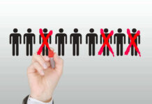 Grocery Chain IMPLOSION — 93,000 Jobs ERASED Hand crossing out stick figures with a red marker.