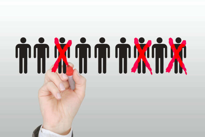 shutterstock_1688476213.jpg Hand crossing out stick figures with a red marker.