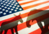 Donkey and elephant shadows on American flag background.