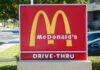 McDonald's drive-thru sign with iconic golden arches
