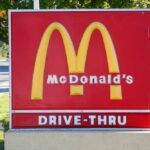 McDonald's drive-thru sign with iconic golden arches