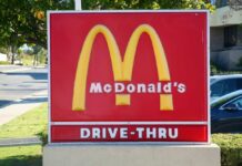 McDonald's drive-thru sign with iconic golden arches