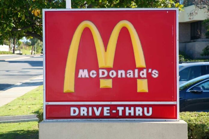 McDonald's drive-thru sign with iconic golden arches