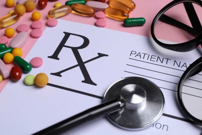 Prescription pad with various colorful pills and a stethoscope