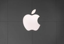 Apple logo displayed on a dark wall