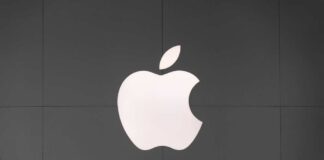 Apple logo displayed on a dark wall