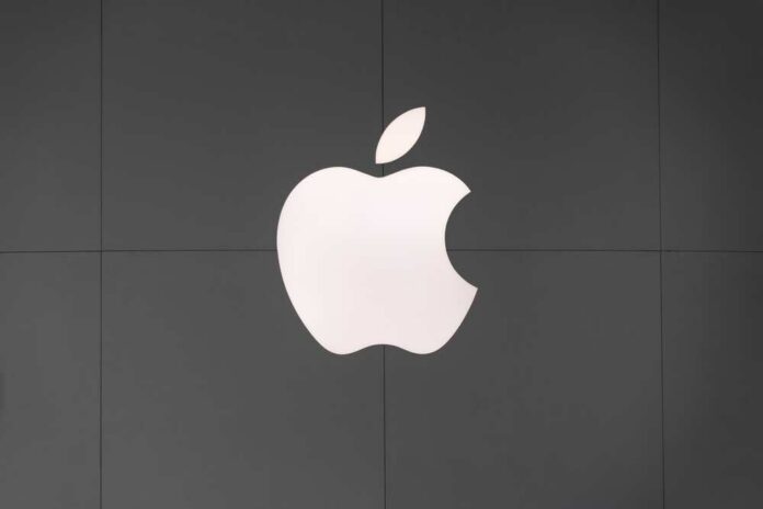 Apple logo displayed on a dark wall