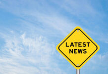 Yellow sign with text Latest News on sky background