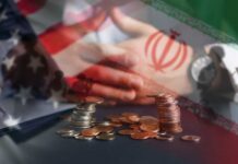 A hand resting on a table with coins stacked in front, overlaid with flags of the US and Iran