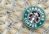 Starbucks coffee logo on a background of hundred dollar bills