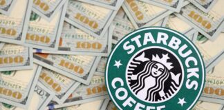 Starbucks coffee logo on a background of hundred dollar bills