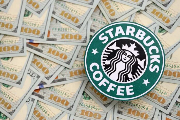 Starbucks coffee logo on a background of hundred dollar bills