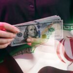 A person holding a stack of US hundred-dollar bills in front of the Iranian flag