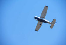 An airplane flying against a clear blue sky