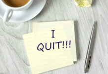 Note with I QUIT near coffee, pen, paper ball.