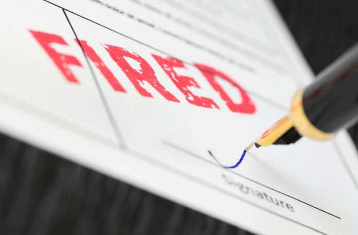 Fountain pen signing document with the word fired