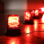 Massacre Foiled: Terror Plot Revealed Red emergency lights on dark floor, illuminating the area.