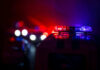 Police car lights shining in the dark.