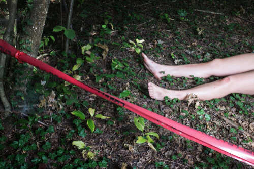shutterstock_1396641035 (1).jpg Bare feet visible near caution tape in a wooded area