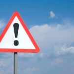 141-Year-Old Company Closing – Family Legacy DESTROYED Triangle warning sign with exclamation mark against sky.