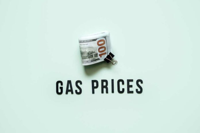 shutterstock_2219438589.jpg A bundle of cash next to the words 'GAS PRICES' on a light green background