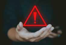 ICONIC Search Engine DEAD A hand holding a red warning triangle with an exclamation mark