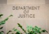$250M Bribery Case DISMISSED by DOJ Sign displaying 'Department of Justice' on a stone wall