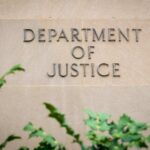 $250M Bribery Case DISMISSED by DOJ Sign displaying 'Department of Justice' on a stone wall