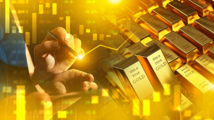 shutterstock_2498221953 Hand writing near stacked gold bars and charts